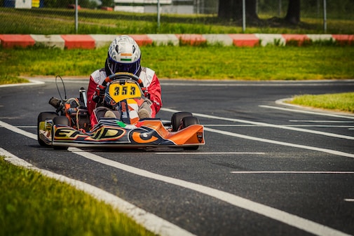 Go-kart on a dry track approaching a corner.