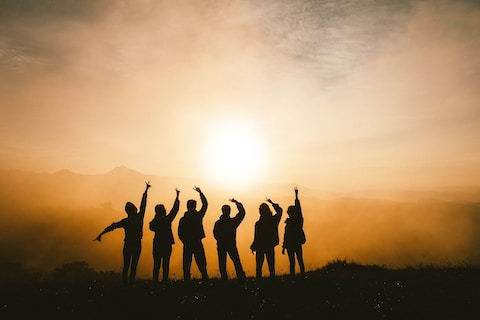 Group celebrating at sunset